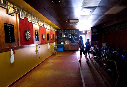 Helen Basista from Des Plaines, IL shoots darts at Gamblers Bar in the Albany Park neighborhood of Chicago on June 14, 2009. © The Chicago Tribune 2009